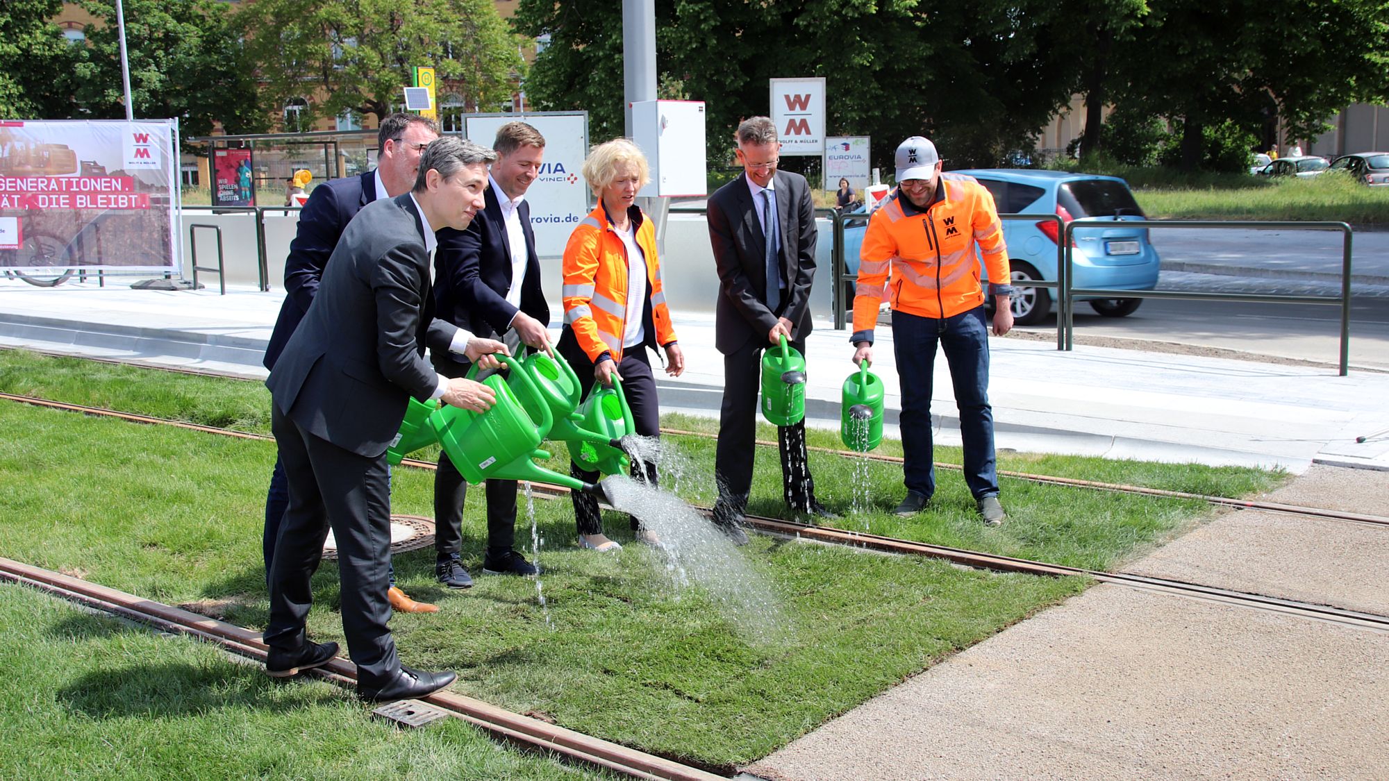 In einer symbolischen Aktion haben Vertreter von Stadt, Land, Baufirma und DVB das letzte Stückchen Rasen zwischen die Gleise auf der Hansastraße gelegt und begossen. Foto: J. Frintert